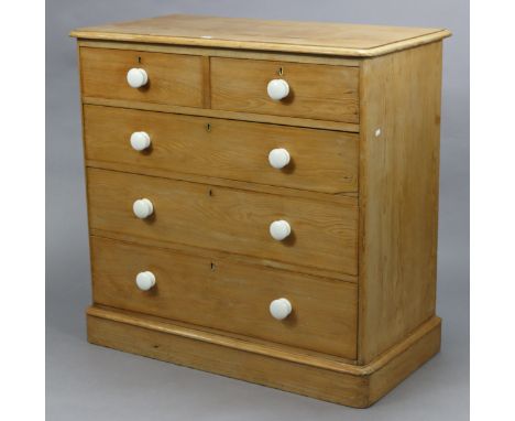 A Victorian pine chest fitted two short &amp; three long graduated drawers with ceramic knob handles, &amp; on a plinth base,