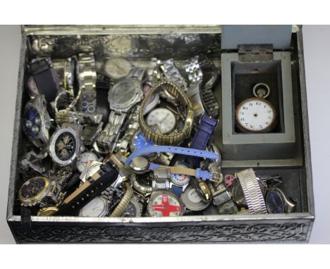 A vintage metal tin containing a quantity of mixed wristwatches inclusing a boxed pocketwatch.