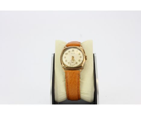 A vintage Avia 9ct gold cased chronographic wristwatch on a brown leather strap.