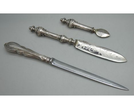 A Lily pattern letter opener with silver handle, and a .800 silver handled German orange peeler, etc.