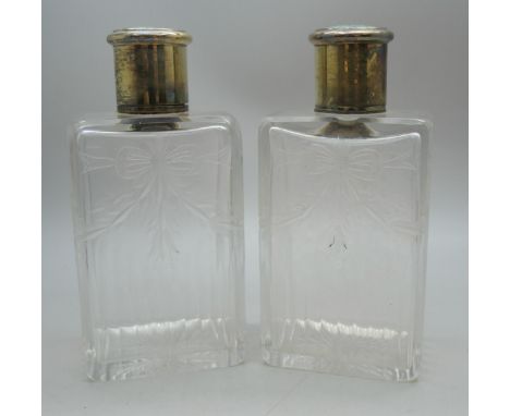 A pair of Edwardian glass scent bottles with etched bow decoration and silver shagreen tops, Mappin &amp; Webb, London, 1908,