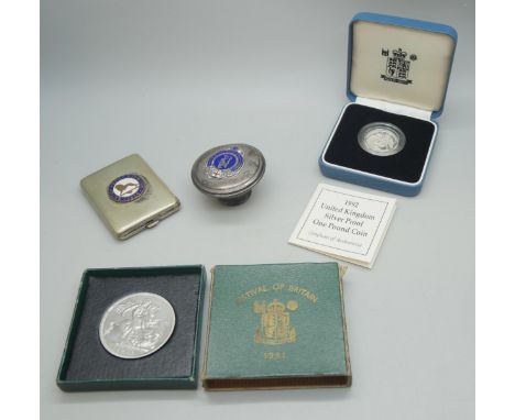 A 1924 British Empire Exhibition enamelled match book case, a 1992 UK silver proof one pound coin, a Festival of Britain crow