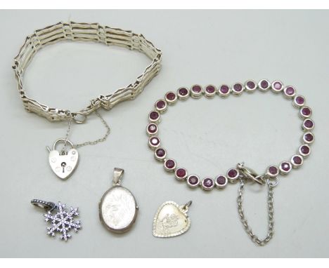 A silver gate bracelet, a silver and ruby tennis bracelet, a silver locket, a silver pendant, and a silver Pandora charm, 35g