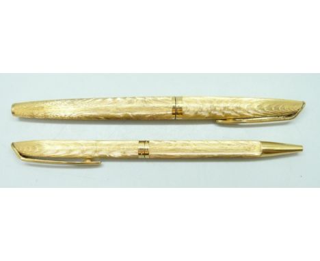 A Waterman CF Moire gold plated fountain pen with an 18k gold nib (section of inlay missing on grip), together with the match