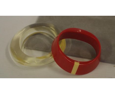 Two modern bangles including a red Art Deco style marked 'Monet'