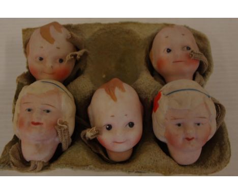 Five vintage ceramic kewpie and doll heads