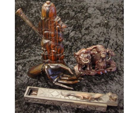 Four Oriental carved timber pieces to include a temple dog figure and pipe, a lizard and frog chopstick box and contents and 
