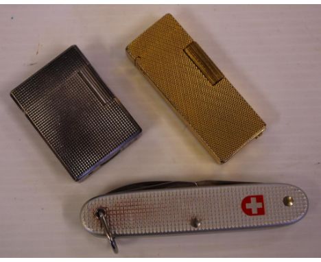 Vintage S T Dupont Paris cigarette lighter silver tone, together with a vintage gold tone lighter and a Swiss army knife