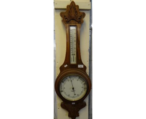 Early 20th century carved oak aneroid barometer marked 'Felix Martin, Swansea'.  (B.P. 21% + VAT) 