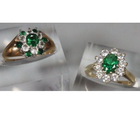 Two 9ct green and clear stone flowerhead rings. 6.7g approx. Sizes H and K. (2) (B.P. 21% + VAT)
