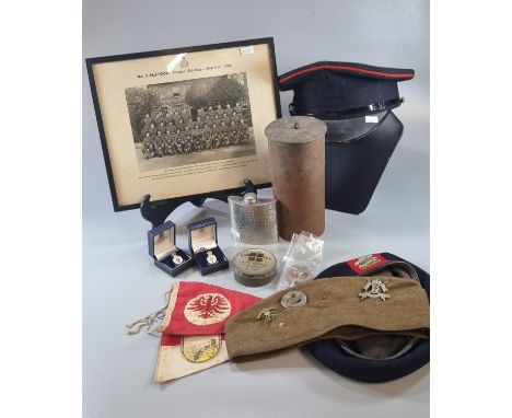 Wicker box of assorted Miliaria items to include: Cap, photograph, Forage cap with badges, Welsh Beret, pennants, hip flask, 