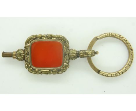 A 19th century over-sized gilt-metal pocket watch key, set with a panel of agate. P&amp;P Group 0 (£6+VAT for the first lot a
