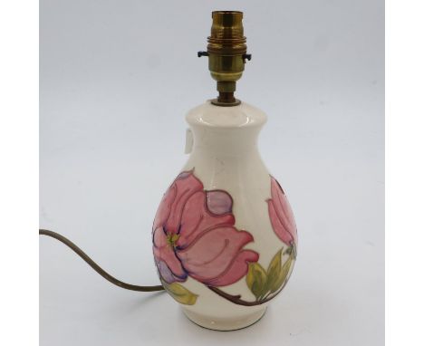 Cream ground Moorcroft table lamp base in the Pink Magnolia pattern, H: 28 cm, has hairline crack down side. UK P&amp;P Group