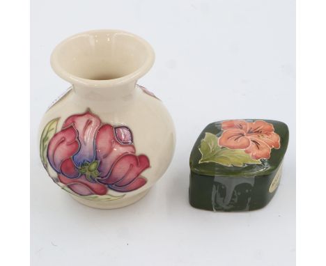 Moorcroft trinket box in the hibiscus pattern and a Moorcroft vase in the magnolia pattern, largest H: 90 mm, no chips or cra