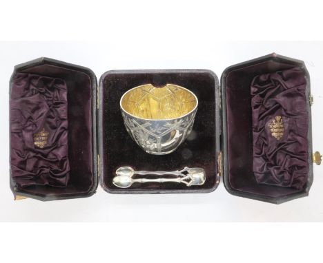 Hallmarked silver boxed bowl in the Canton style, relief decorated with gilt washed interior and a pair of tongs, cased, Birm