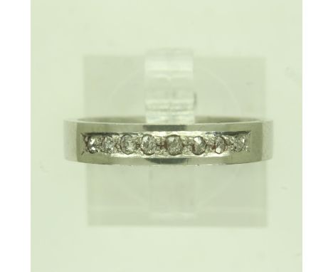 Contemporary platinum band ring, channel-set with eight diamonds, size M/N, 5.4g. UK P&amp;P Group 0 (£6+VAT for the first lo