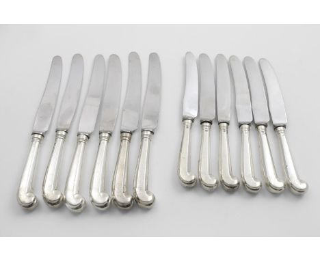 AN EDWARDIAN SET OF SIX TABLE KNIVES AND SIX SIDE KNIVES with octagonal pistol handles and stainless steel blades, crested, b