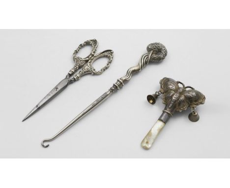 A GEORGE V CHILD'S RATTLE in the form of a butterfly with two bells dependent and a mother of pearl teething stick, by Crisfo