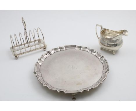 A GEORGE V SALVER of shaped circular outline with a moulded border, crested, by Barker Brothers, Chester 1919, together with 