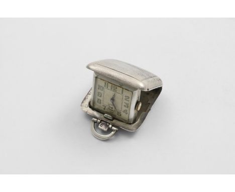 AN ART DECO TRAVELLING TIMEPIECE in a folding, engine-turned case, with a cream coloured dial and luminous numerals, maker's 