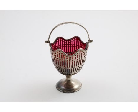 A GREAT WAR PERIOD SWING HANDLED SUGAR BASKET with a wavy rim, bead borders and a cranberry glass liner, by G. Nathan &amp; R