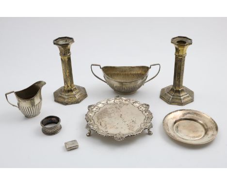 A MIXED LOT:- A waiter, a part fluted cream jug and sugar basin, a small dish, a napkin ring, a George III vinaigrette and a 
