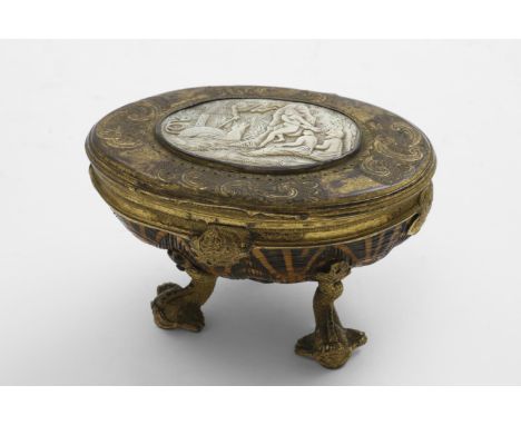 A GEORGE II GILT-METAL MOUNTED TERRAPIN SHELL TABLE SNUFF BOX on three dolphin supports with an applied, chased mask below th