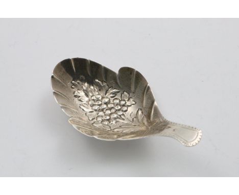 A GEORGE III IRISH CADDY SPOON with a short, feather-edge stem and a leaf-shaped bowl with chased flowers in the centre, no m