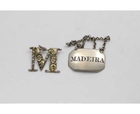 A GEORGE IV SMALL CANTED OBLONG WINE LABEL with a feather-edge, incised and filled "MADEIRA", by Lea &amp; Co., Birmingham 18