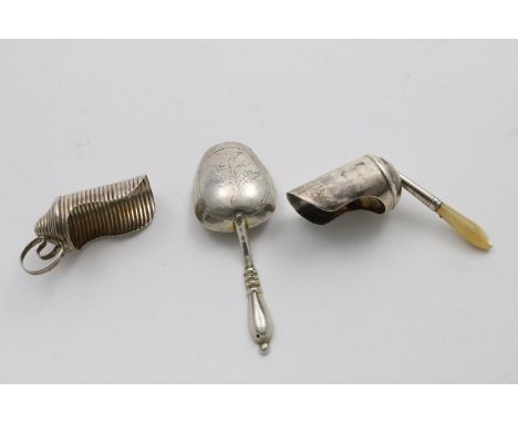 THREE CADDY SCOOPS:- A George III ribbed example with a shaped ring handle, no maker's mark, Birmingham 1802, another with a 