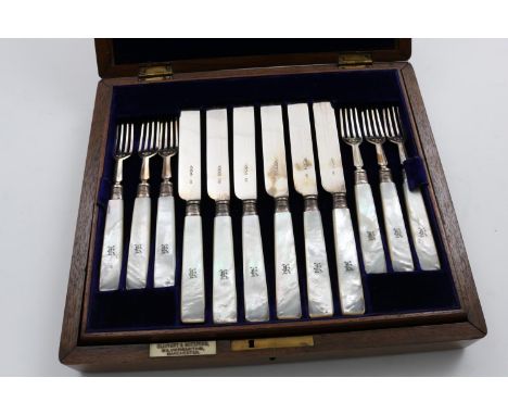 A LATE VICTORIAN CASED SET OF TWELVE PAIRS OF DESSERT KNIVES AND FORKS with mother of pearl handles, initialled, by Harrison 