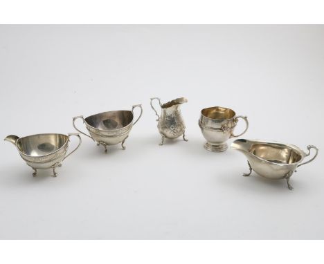 A GREAT WAR PERIOD CIRCULAR CREAM JUG AND SUGAR BASIN with engraving and four feet by W. Atkin, Birmingham 1915, a Victorian 