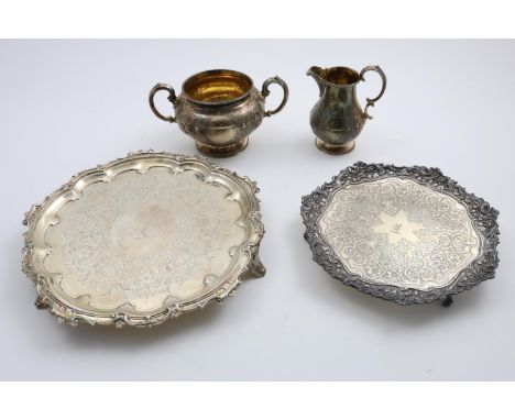 A VICTORIAN ENGRAVED SALVER of shaped circular outline with a scroll border, crested, by Henry Wilkinson, London 1859, togeth