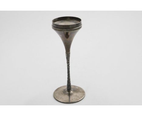 AN ELIZABETH II SINGLE CANDLESTICK with a textured stem on a circular base and a flaring capital, by Stuart Devlin, London 19