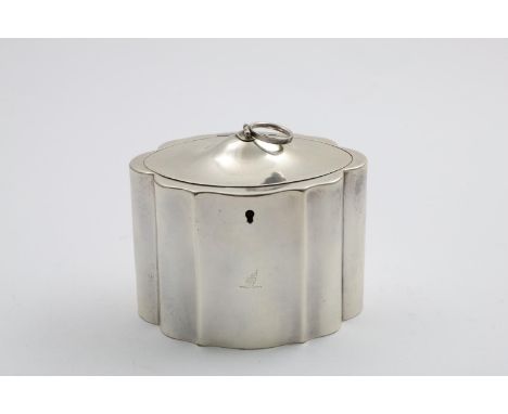 A GEORGE III TEA CADDY of shaped oval outline with a domed cover, folding ring finial and a lock, crested, by John Scofield, 