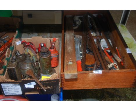 A box of miscellaneous including Oil cans, small hydraulic Jack, spirit level, etc.