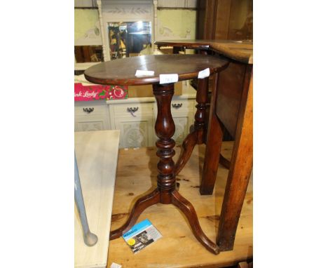 An oval Mahogany snap top occasional table on tripod base.   