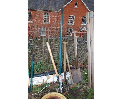 Garden equipment including: Two shovels, sledge hammer, pick axe,a fork and a long arm pruner.