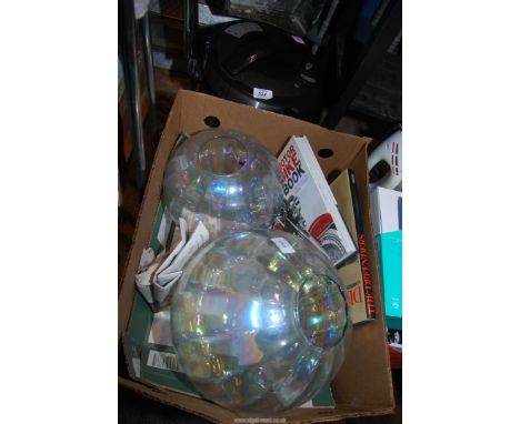 Two globe light shades, and two books, plus a pressure cooker, etc.
