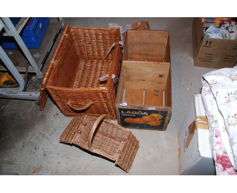 Picnic hamper and other small baskets and an orange crate.
