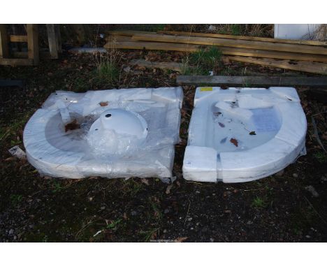 Two corner shower bases and a hand basin.