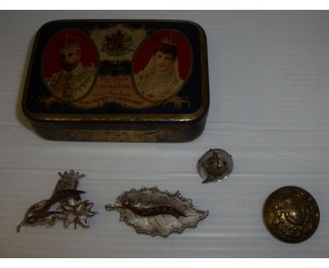 Queen Mary coronation tin containing two sweetheart brooches marked Ypres and Arras, mother of pearl brooch and military butt