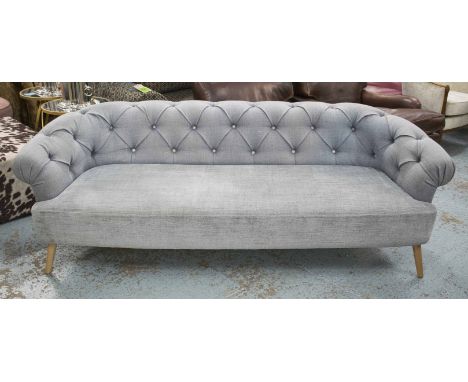 DESIGNERS GUILD SOFA, with deep button upholstered back and arms in grey fabric on swept supports, 72cm H x 220cm W x 95cm D.