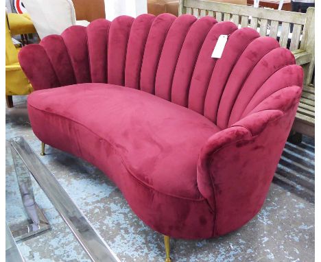 SHELL BACK SOFA, early 20th century style, shaped seat in red upholstery on brass stilt legs, 173cm L.