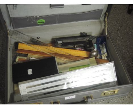 A case containing a selection of draughtsmans tools including a vintage Valos Model C stapler etc