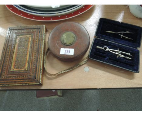 A vintage tape measure, compasses and mirror