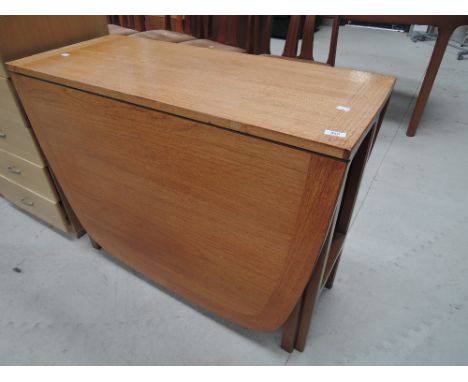 A vintage teak drop leaf dining table