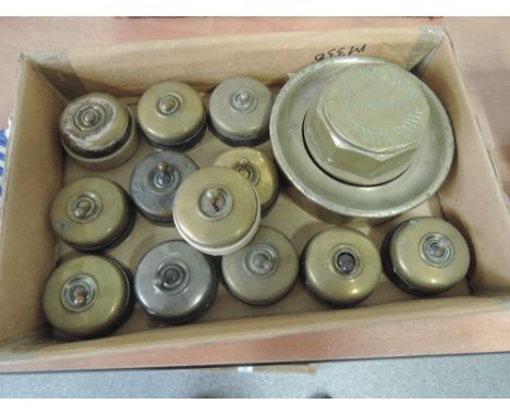 A box of vintage brass light switchesand brass hub cap stamped J D Jackson Builder, Hutton Roof