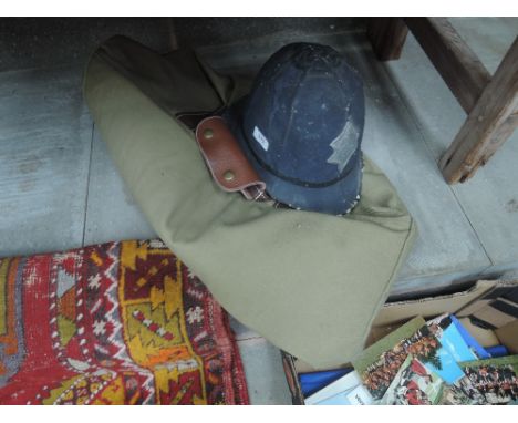 A fabric holdall and a Police helmet theatre prop
