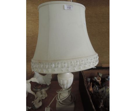 An alabaster table lamp base and shade